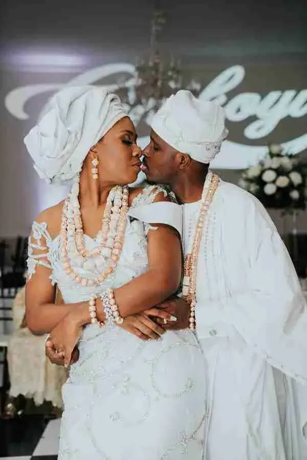 Cultural Wedding Package Deal African couple in traditional attire sharing a kiss during a Houston wedding ceremony