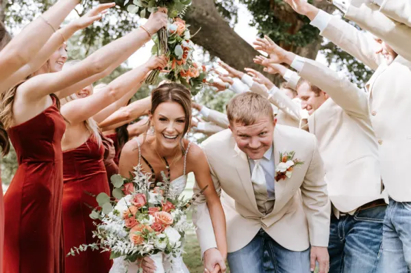Outdoor Ceremony Photo Bundle Bride and groom holding hands under floral arch in forest during their Houston wedding ceremony