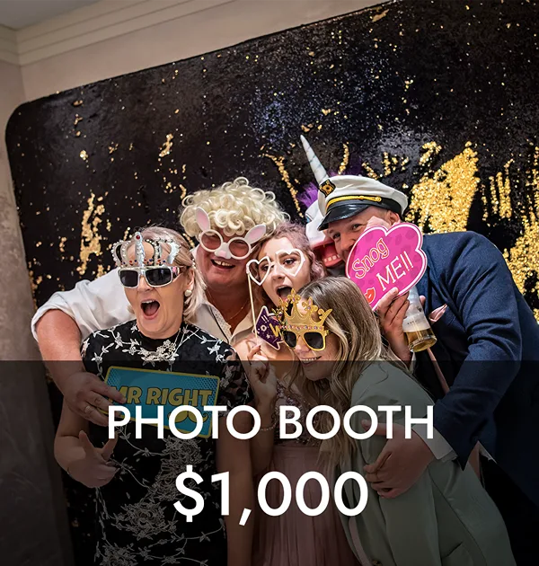 Guests having fun with props at a wedding photo booth in Houston